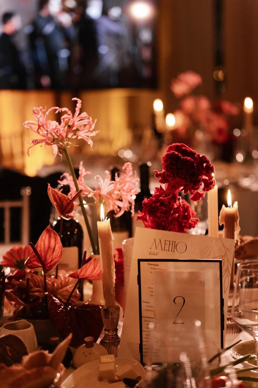 Candlelit reception tablescape with pink and red florals